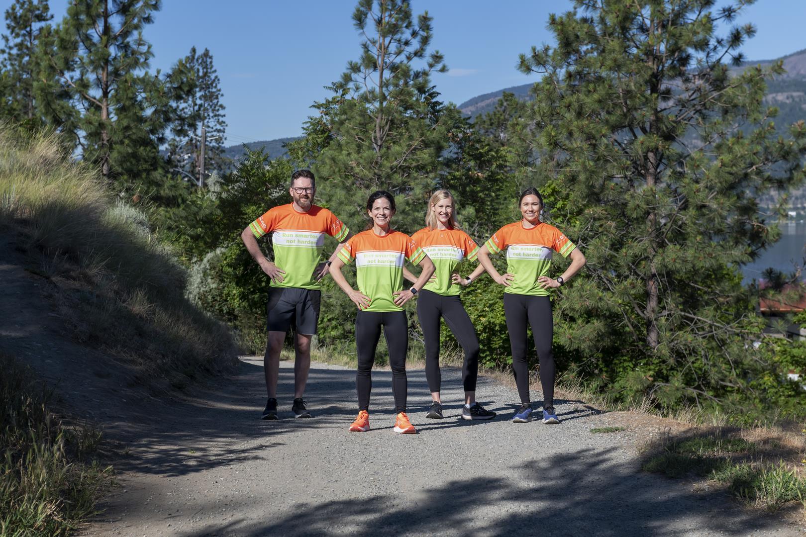 Group standing on trail with hands on hips