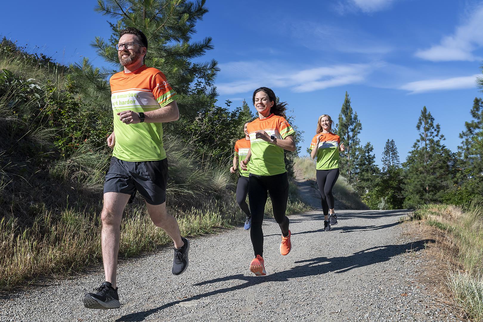 Smiling group running on trail